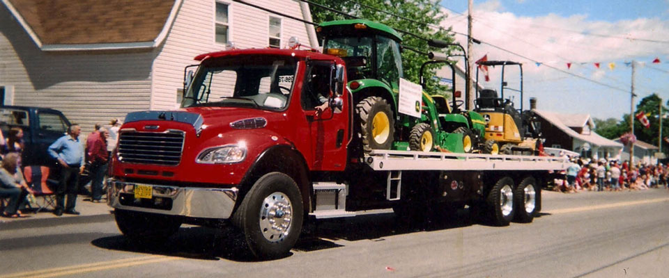 Red truck hauling tractor