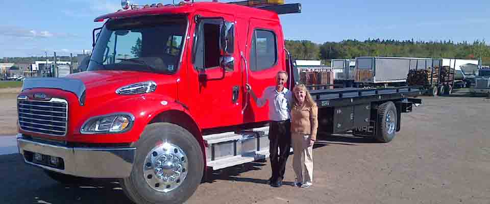 Large red tow truck and couple